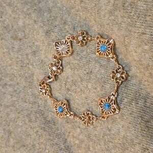 About 8 inch Bracelet with Clear/Blue faux Stones .Includes a clasp.